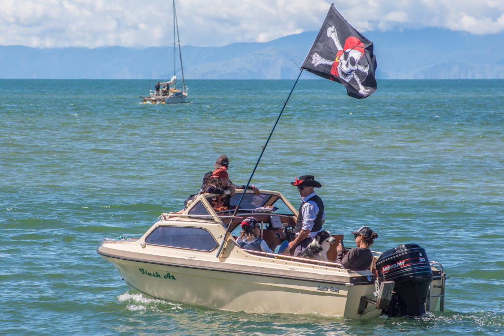 motor boat with pirate flag and crew